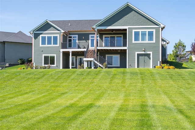9441 Coneflower Cir, Norwalk, IA 50211 - rear view of property with ceiling fan, a wooden deck, stairway, and a lawn