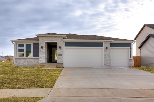 prairie-style house featuring a front yard and a garage