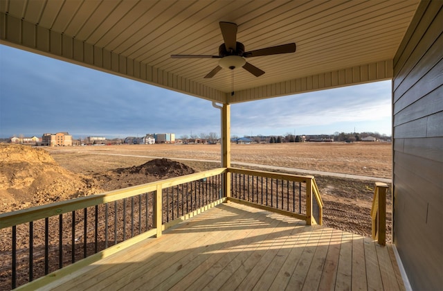 wooden deck with ceiling fan and a rural view