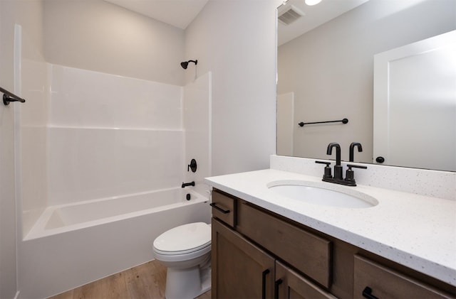 full bathroom with shower / washtub combination, toilet, vanity, and wood-type flooring