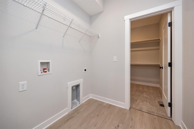 laundry room featuring hookup for a washing machine, light hardwood / wood-style flooring, and hookup for an electric dryer