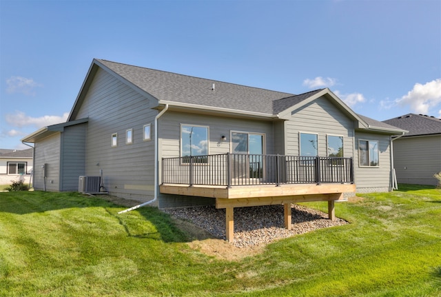 rear view of house with a lawn, central air condition unit, and a wooden deck