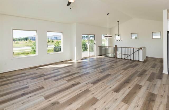 unfurnished room with hardwood / wood-style flooring, ceiling fan, and vaulted ceiling