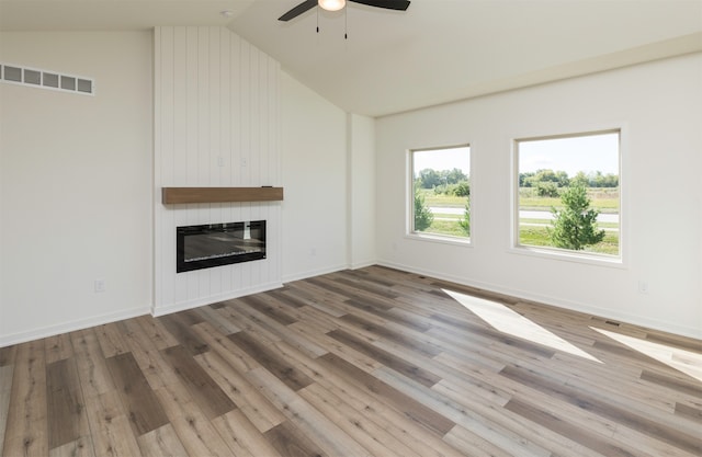 unfurnished living room with a fireplace, hardwood / wood-style floors, vaulted ceiling, and ceiling fan