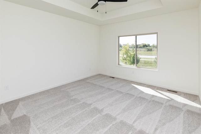 8924 Beery Pl, Johnston, IA 50131 - carpeted spare room featuring a tray ceiling, a ceiling fan, and baseboards