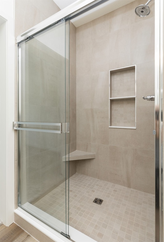 bathroom featuring hardwood / wood-style floors and an enclosed shower