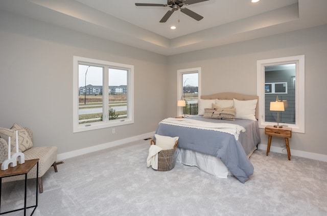 bedroom with ceiling fan, carpet floors, and multiple windows