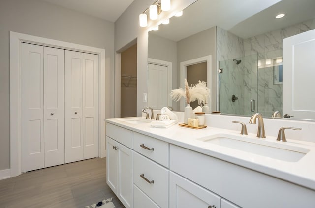 8908 Beery Pl, Johnston, IA 50131 - bathroom featuring a closet, a marble finish shower, and double vanity