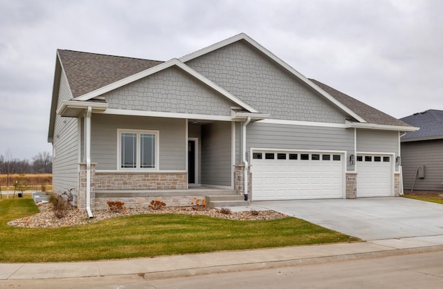 8908 Beery Pl, Johnston, IA 50131 - craftsman-style home featuring a garage, stone siding, concrete driveway, a front lawn, and a shingled roof