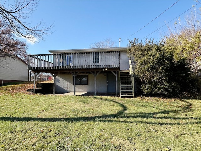 rear view of house with a yard, stairway, and a wooden deck