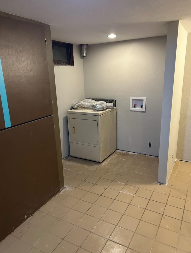 washroom featuring washer / dryer, laundry area, and light tile patterned floors