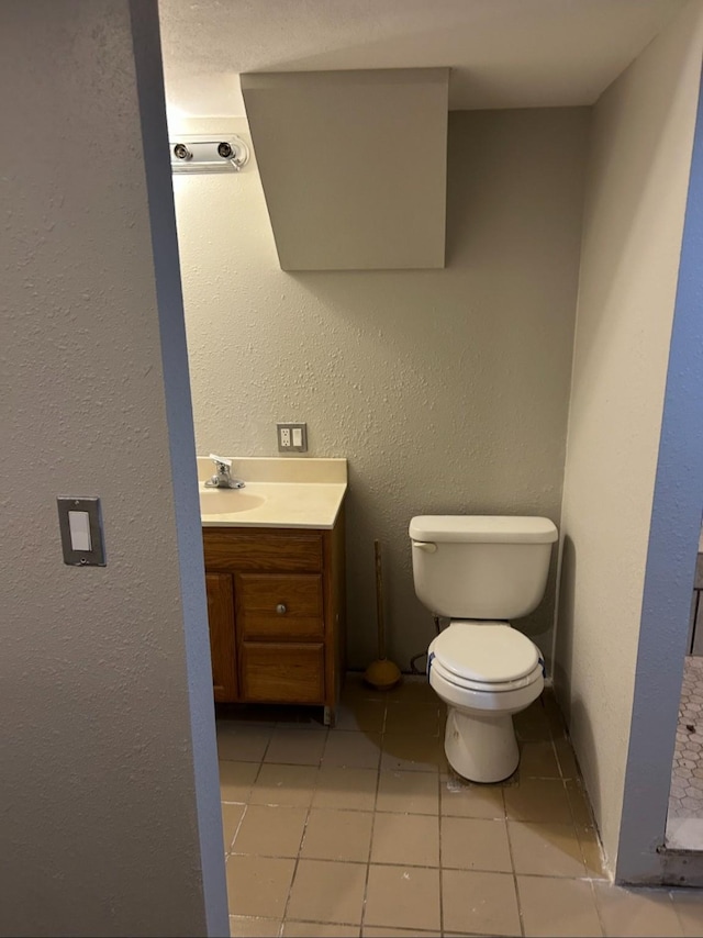 bathroom featuring vanity, toilet, and tile patterned floors