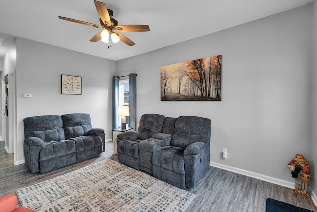 living room featuring hardwood / wood-style flooring and ceiling fan