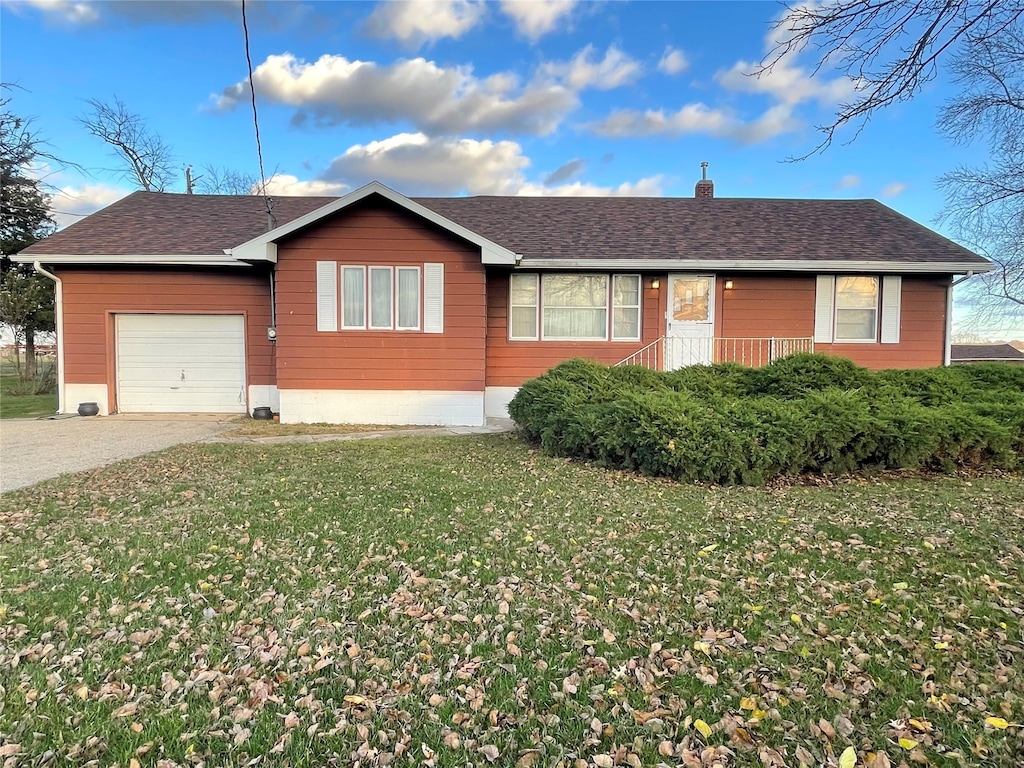 single story home with a garage and a front yard