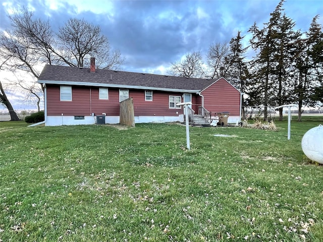 back of property featuring a lawn and cooling unit