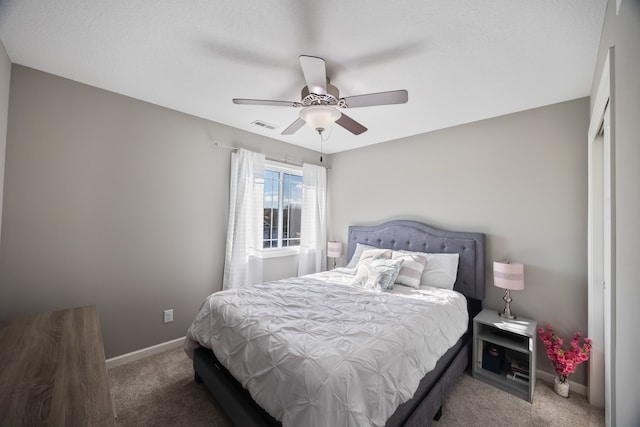 carpeted bedroom with a closet and ceiling fan