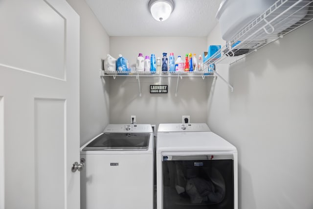 laundry area featuring independent washer and dryer and a textured ceiling