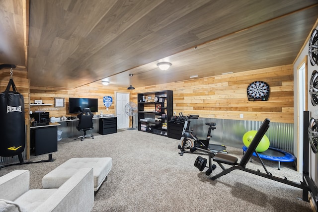 workout area featuring wood walls, built in desk, carpet floors, and wooden ceiling