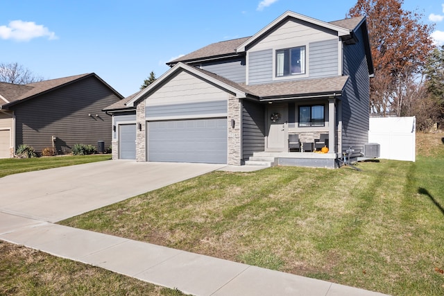 craftsman-style home with a front yard and central air condition unit