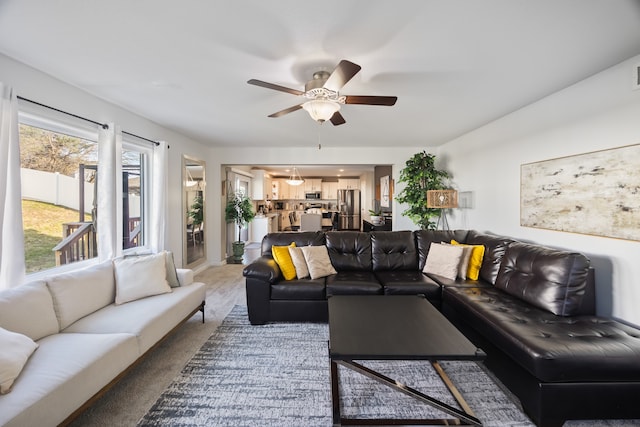 living room featuring carpet and ceiling fan