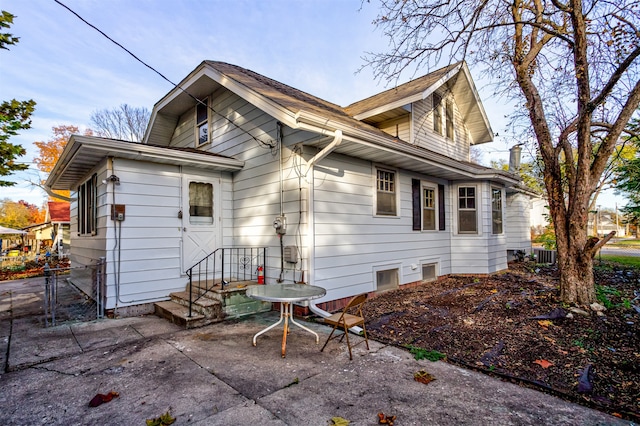 rear view of house featuring central AC and a patio area