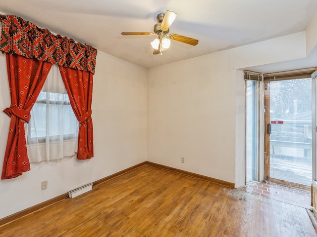 unfurnished room with ceiling fan and hardwood / wood-style floors