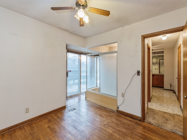 spare room with wood-type flooring and ceiling fan