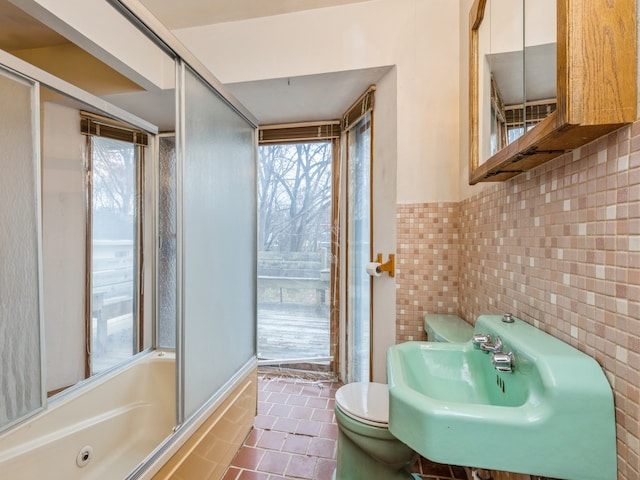 full bathroom with shower / bath combination with glass door, tile patterned floors, toilet, and sink