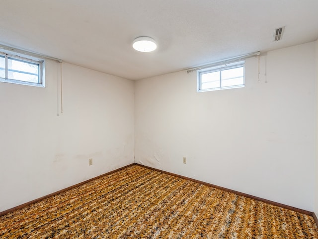 basement featuring carpet flooring and a healthy amount of sunlight