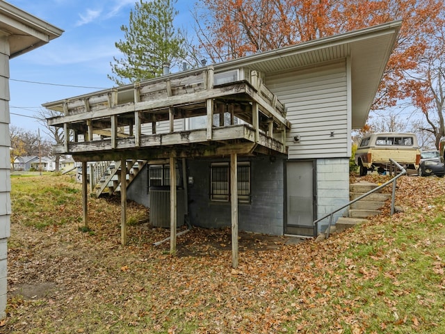 rear view of house with a deck and central air condition unit