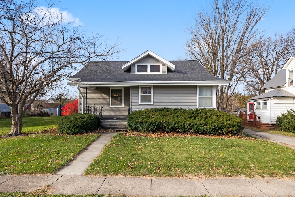 bungalow-style home featuring a front yard