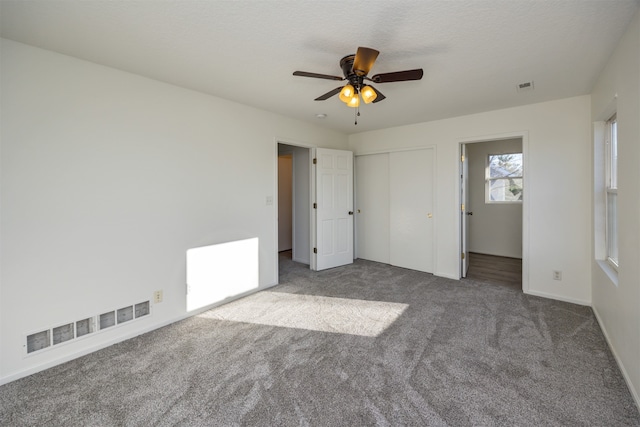 unfurnished bedroom with carpet flooring and ceiling fan