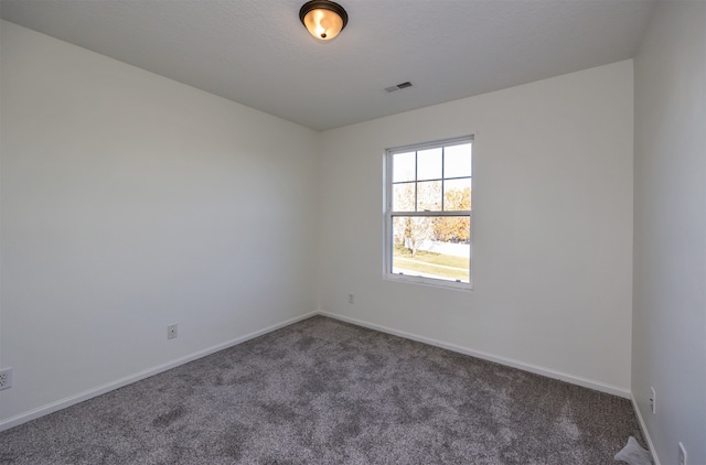 empty room with dark carpet