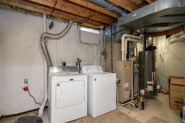 clothes washing area with washer and dryer and gas water heater