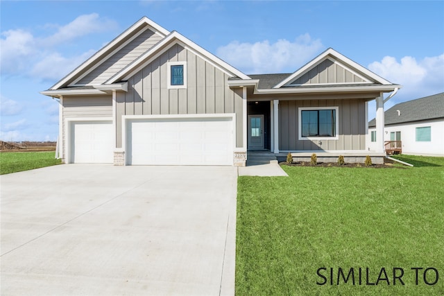 view of front of home featuring a front yard and a garage