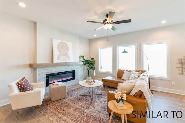 living room featuring hardwood / wood-style flooring and ceiling fan