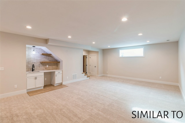 interior space with light colored carpet and sink