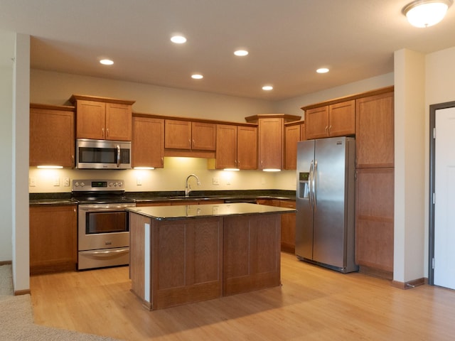 1370 SW Magazine Rd Unit 206, Ankeny, IA 50023 - kitchen with stainless steel appliances, dark countertops, a center island, brown cabinetry, and recessed lighting