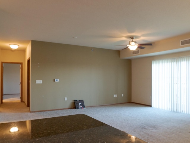 1370 SW Magazine Rd Unit 206, Ankeny, IA 50023 - empty room featuring light colored carpet, ceiling fan, and baseboards