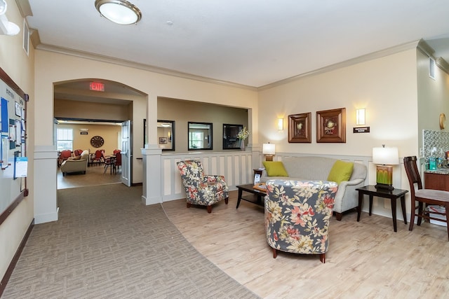 1370 SW Magazine Rd Unit 206, Ankeny, IA 50023 - living room featuring arched walkways, ornamental molding, light wood-style flooring, and baseboards