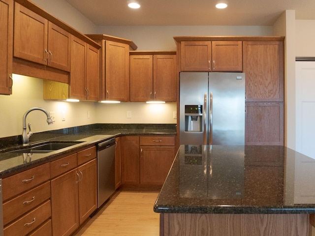 1370 SW Magazine Rd Unit 206, Ankeny, IA 50023 - kitchen featuring appliances with stainless steel finishes, a sink, light wood-style flooring, brown cabinets, and recessed lighting