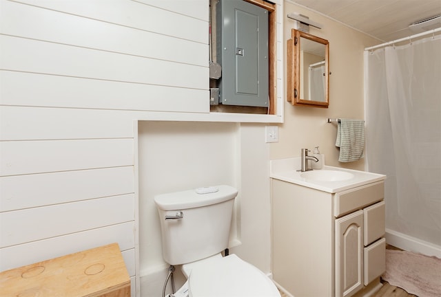 bathroom featuring a shower with curtain, electric panel, toilet, vanity, and hardwood / wood-style flooring