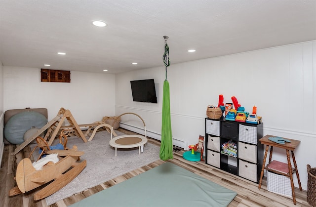 recreation room featuring light hardwood / wood-style floors