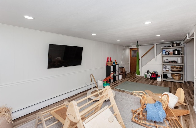 interior space featuring a baseboard radiator, recessed lighting, and wood finished floors