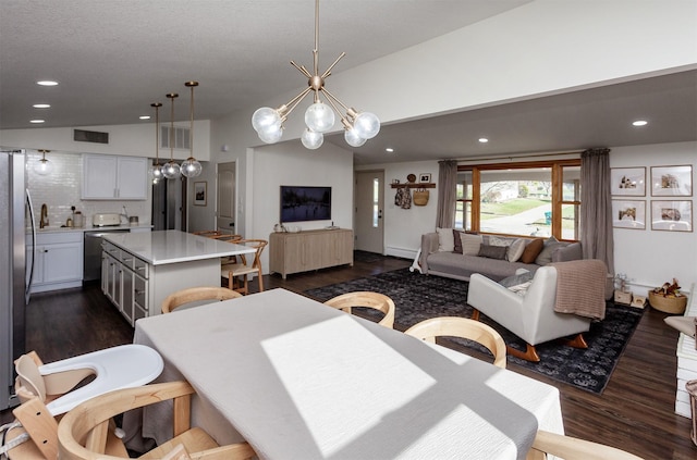 dining space with lofted ceiling, dark wood-style floors, visible vents, and recessed lighting