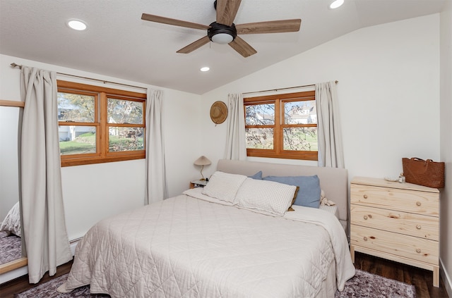 bedroom featuring ceiling fan, dark wood-type flooring, and vaulted ceiling