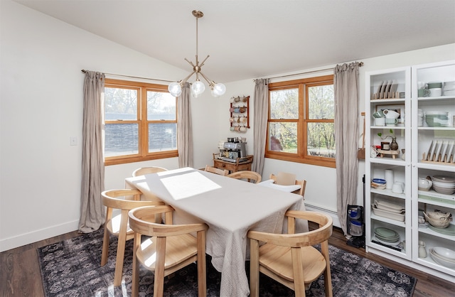 dining room featuring dark hardwood / wood-style flooring, an inviting chandelier, vaulted ceiling, and plenty of natural light