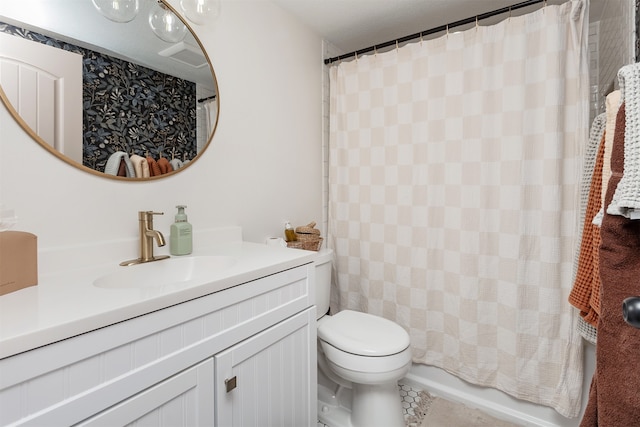 full bathroom with tile patterned floors, shower / bath combo with shower curtain, vanity, and toilet