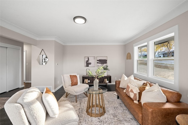 living room with hardwood / wood-style floors and crown molding