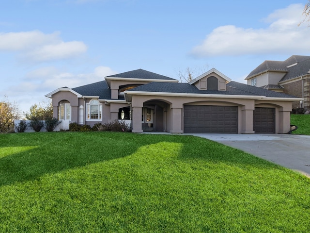 view of front of property with a front lawn and a garage